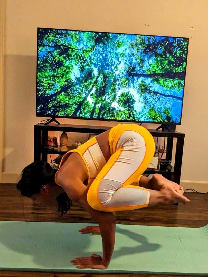 Crow pose arm balance during home practice.